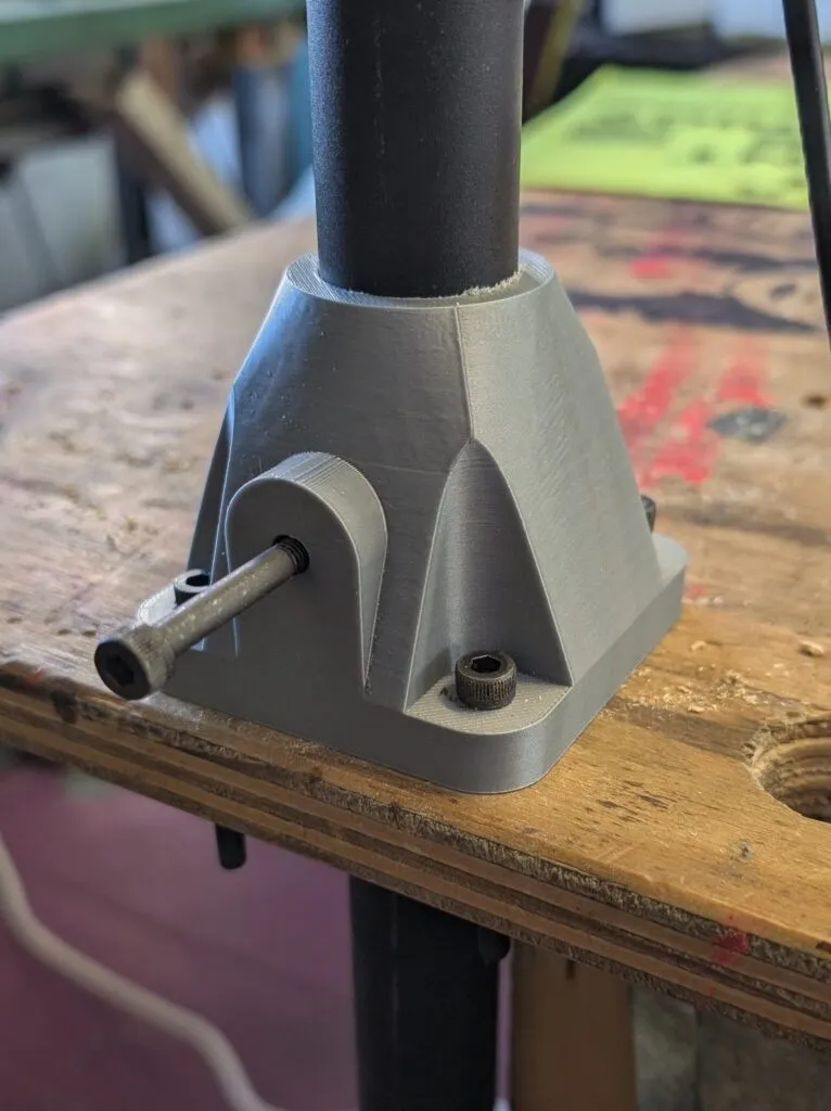 The printed bracket, bolted to the table with a clamping bolt installed
